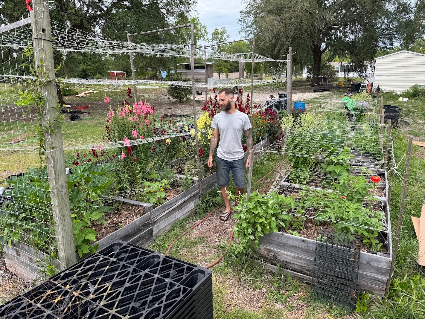 Travis Tift, Master Horticulturalist, walking through raised garden beds at Bagshot Row Pepper Farm